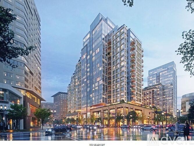 A tall building with many windows is the focal point of the image.