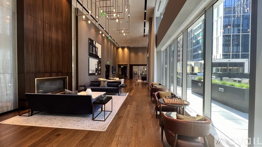 A long hallway with a couch and chairs on either side.