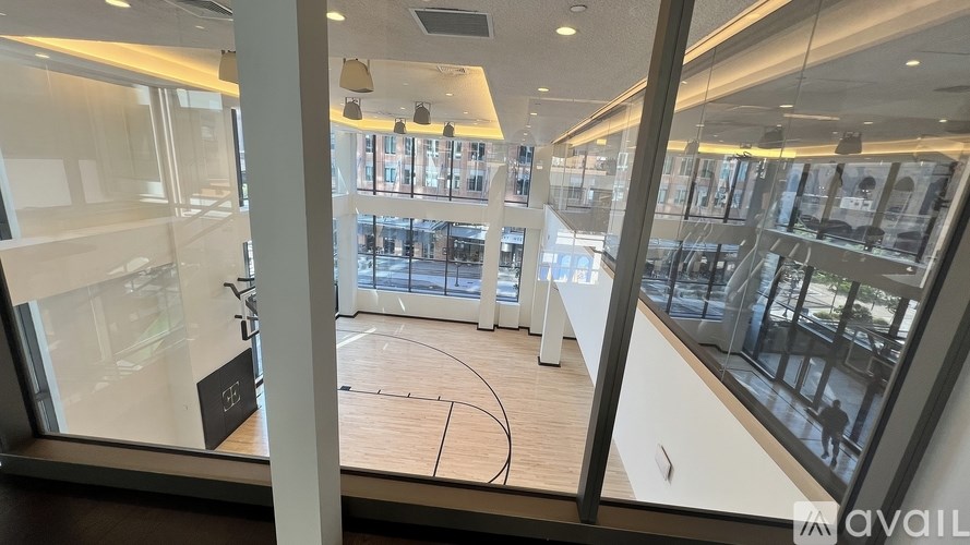 A view from inside a building looking out to a basketball court.