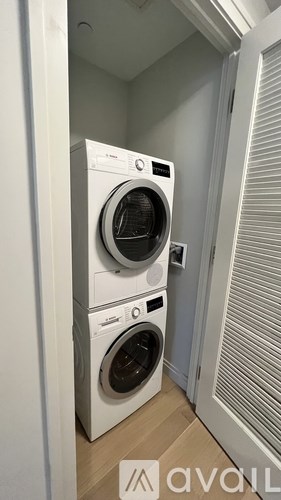 Two front loading washing machines in a laundry room.