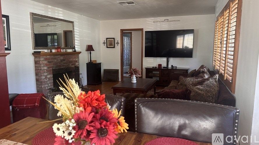 A living room with a fireplace and a couch.