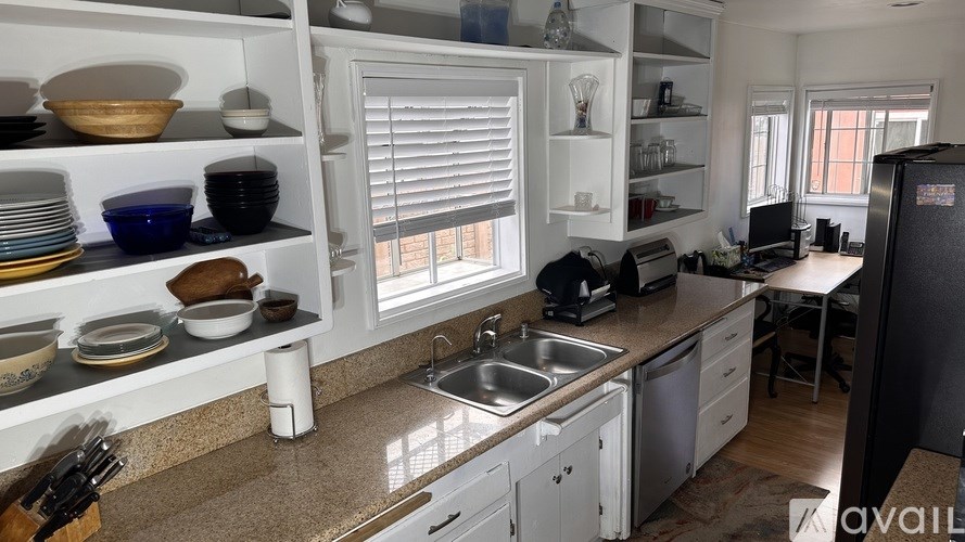 A kitchen with a sink, stove, and refrigerator.