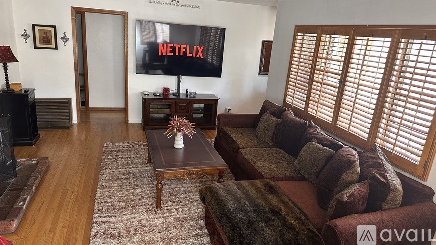 A living room with a Netflix screen on the wall.