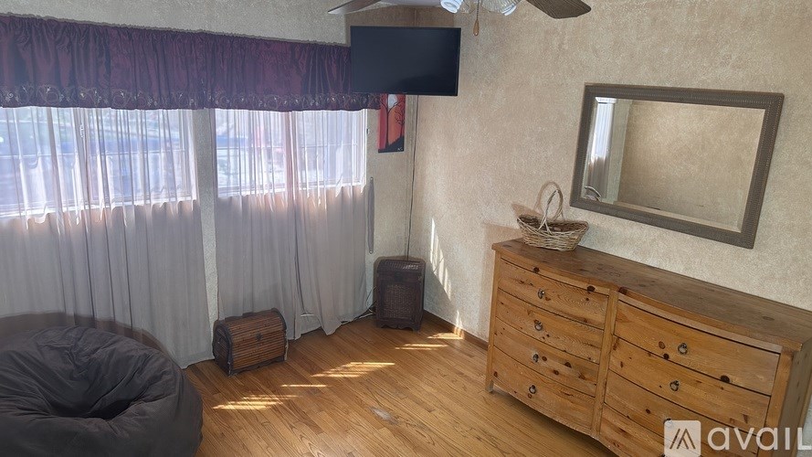 A room with wooden furniture and a ceiling fan.