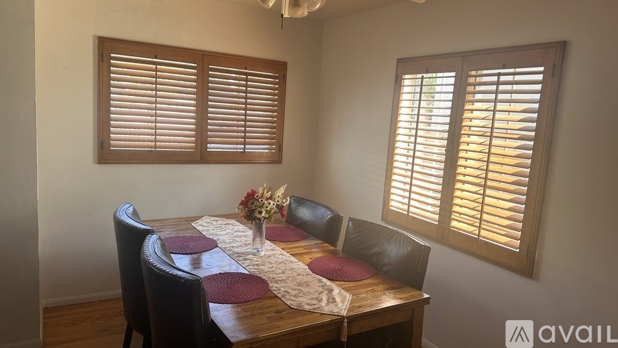 A dining room with a table set for four.