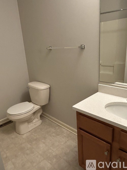 A white toilet sits next to a sink in a bathroom.