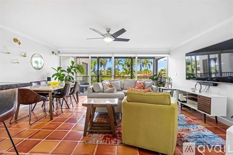 A living room with a yellow sofa and a dining table with chairs.