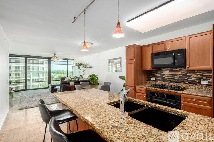 A kitchen with brown cabinets and a granite countertop.