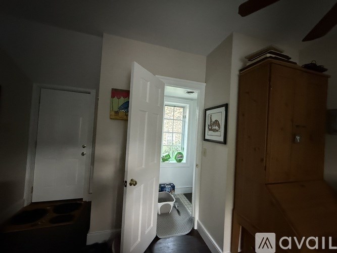 A room with a white door and a painting on the wall.