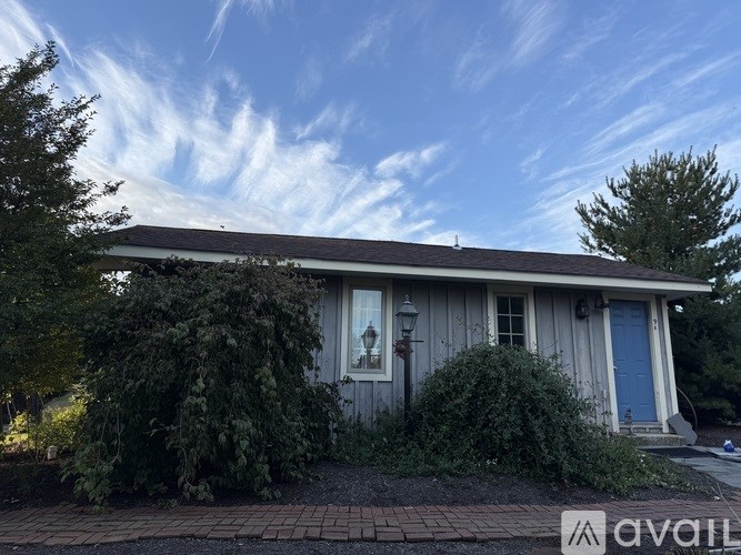 A house with a blue door is for sale.
