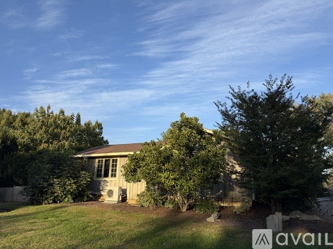 A house with a tree in front of it.