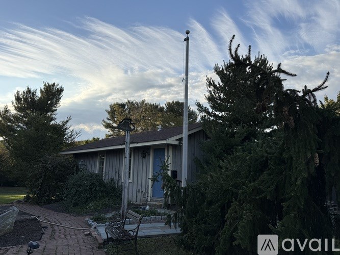 A house with a patio and a tree in front of it.
