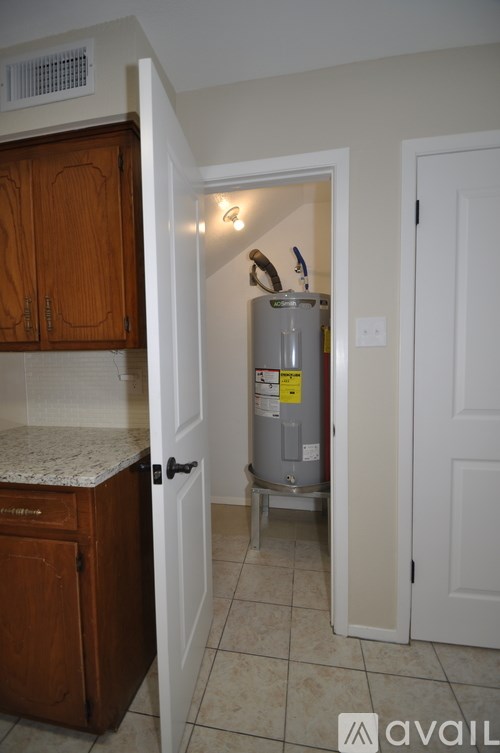 A room with a white door and a brown cabinet.