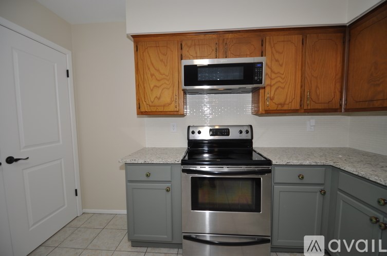 A kitchen with a stove, oven, and microwave.