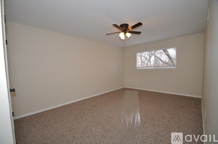 A room with a ceiling fan and a window.