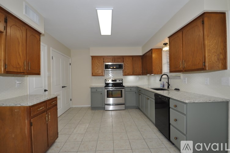 A kitchen with wooden cabinets and a stainless steel oven.