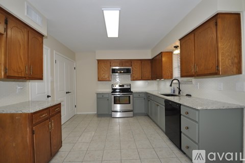 A kitchen with wooden cabinets and a stainless steel oven.