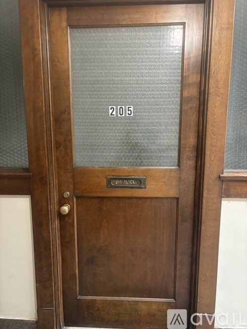 A brown door with a glass window and a plate on it.