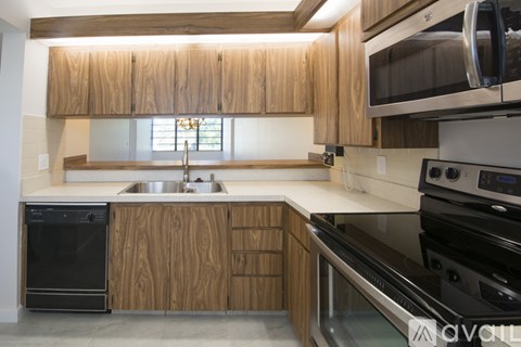 A kitchen with wooden cabinets and stainless steel appliances.