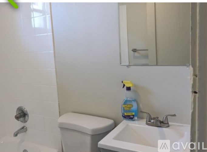A white toilet sits next to a sink in a bathroom.