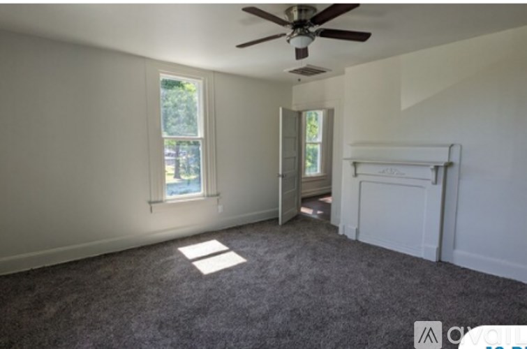 A room with a ceiling fan and a window.