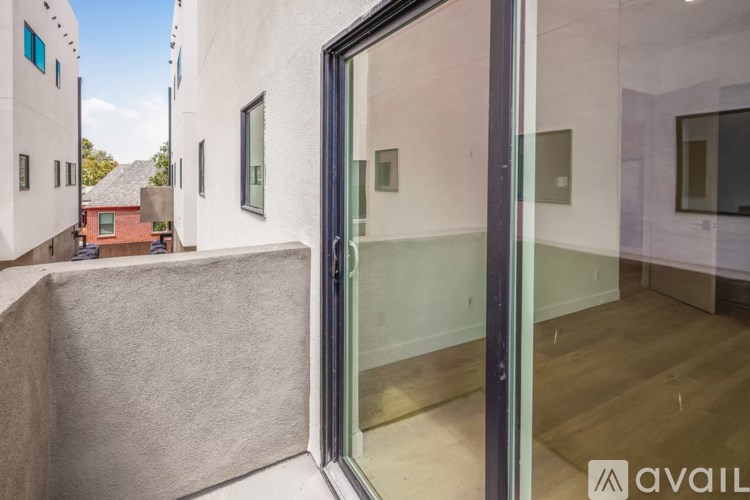 A modern house with a glass door and a balcony.