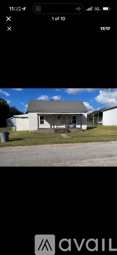 A house with a grey roof and white walls is shown.