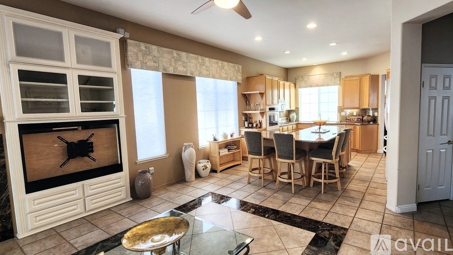 A modern kitchen with a glass table and a fireplace.