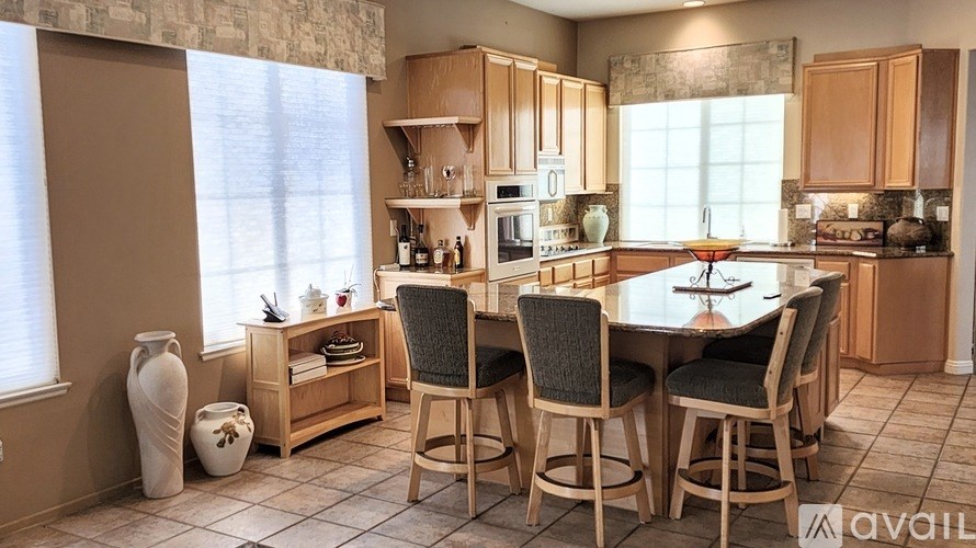 A kitchen with a table and chairs in the middle of the room.