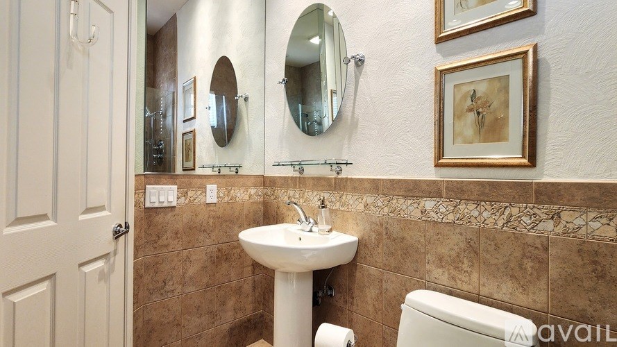 A bathroom with a sink, mirror, and toilet.