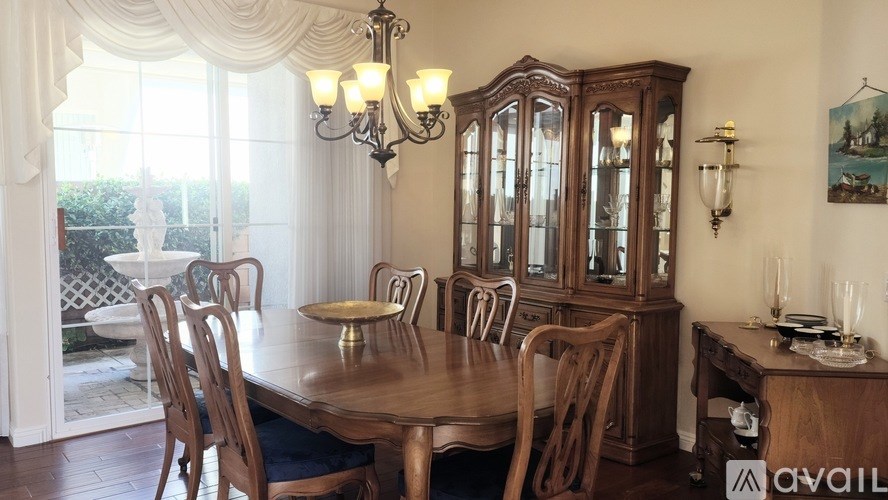 A dining room with a wooden table and chairs.