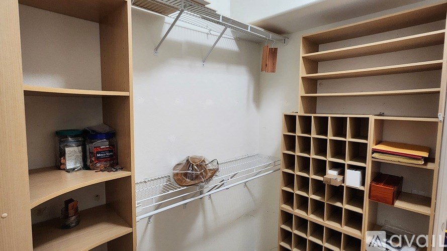 A pantry with shelves and containers on them.