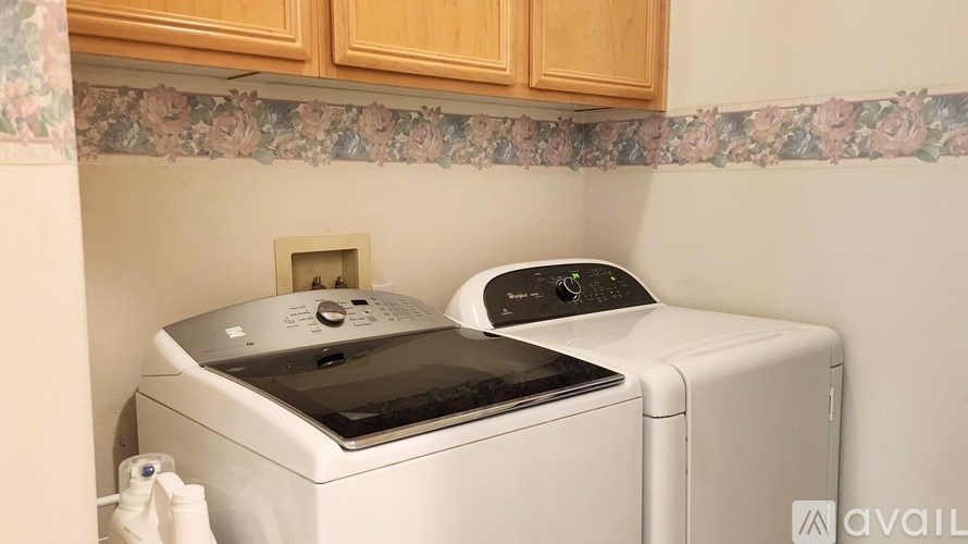 A white washing machine and dryer in a kitchen.