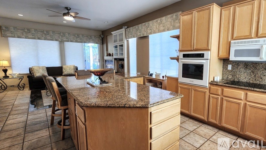 A kitchen with wooden cabinets and granite countertops.