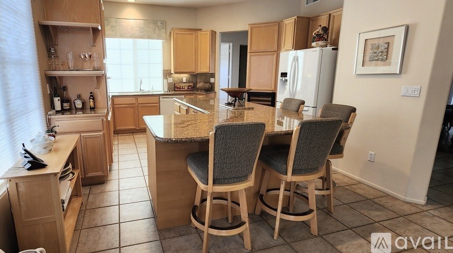 A kitchen with wooden cabinets and a marble countertop.