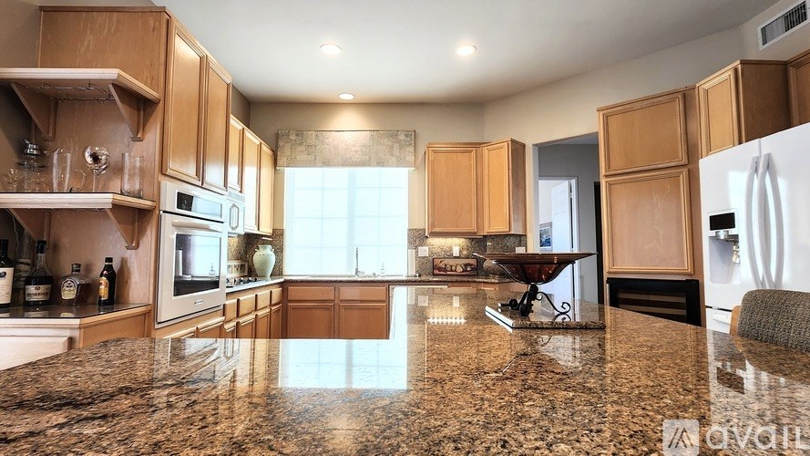 A kitchen with wooden cabinets and granite countertops.