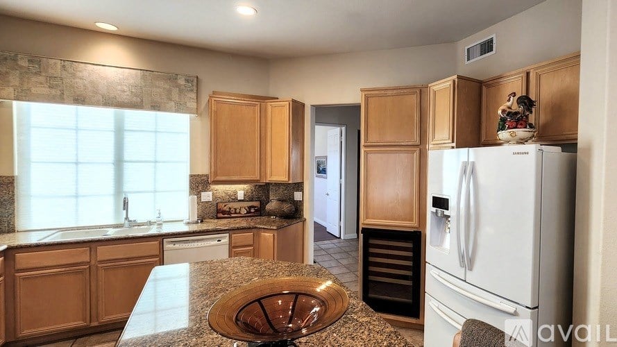 A kitchen with wooden cabinets and a white refrigerator.