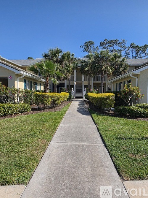 A residential area with a pathway and houses on either side.