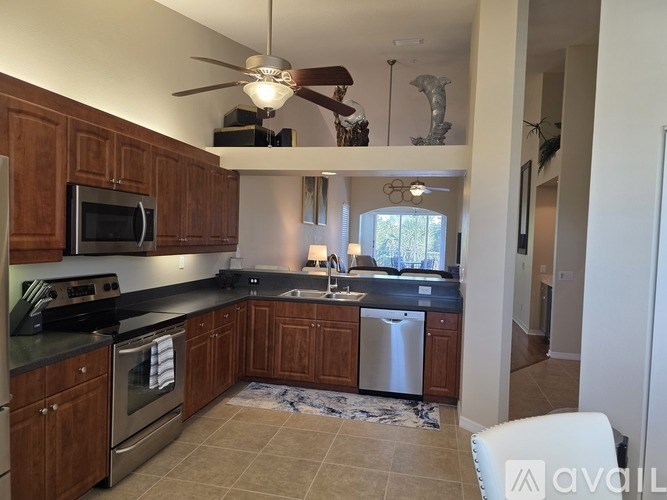 A kitchen with wooden cabinets and a stainless steel dishwasher.