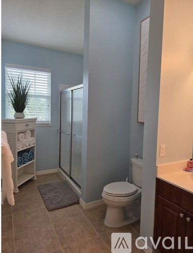 A bathroom with a toilet, sink, and shower.