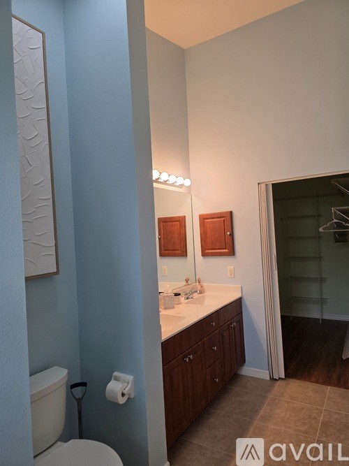 A bathroom with blue walls and a white toilet.