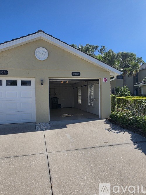 A house with a garage and a sign that says "AVAIL" on the front.