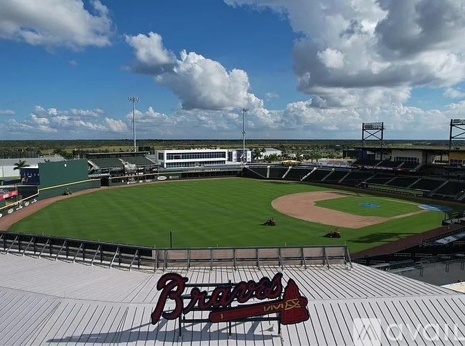 A baseball field with the word "Braves" written on the roof.