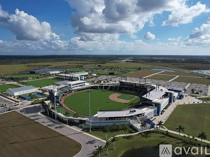 An aerial view of a baseball stadium surrounded by open fields.