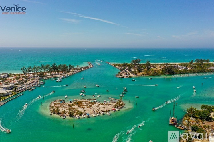 A beautiful aerial view of a Venice marina with boats and clear blue water.