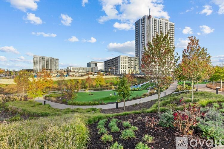 A garden with a sign that says "love" in front of a city skyline.