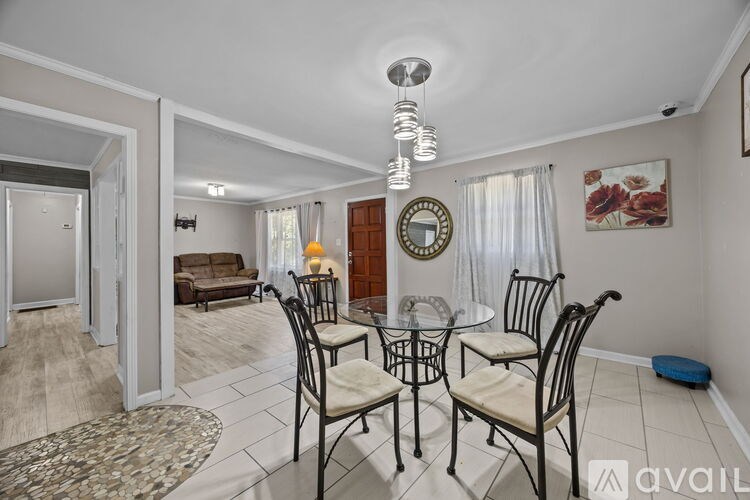 A dining room with a table set for four.
