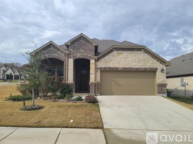 A house with a brick facade and a large garage door.