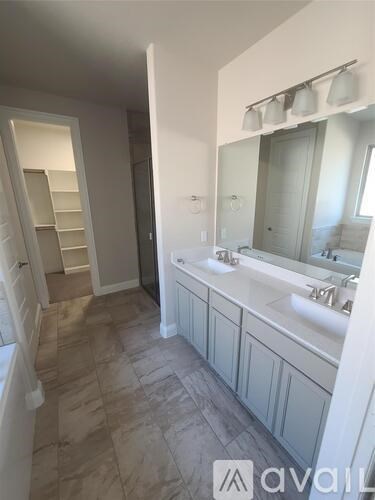 A bathroom with a sink, mirror, and a staircase.