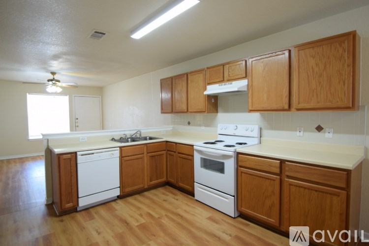 A kitchen with wooden cabinets and white appliances.